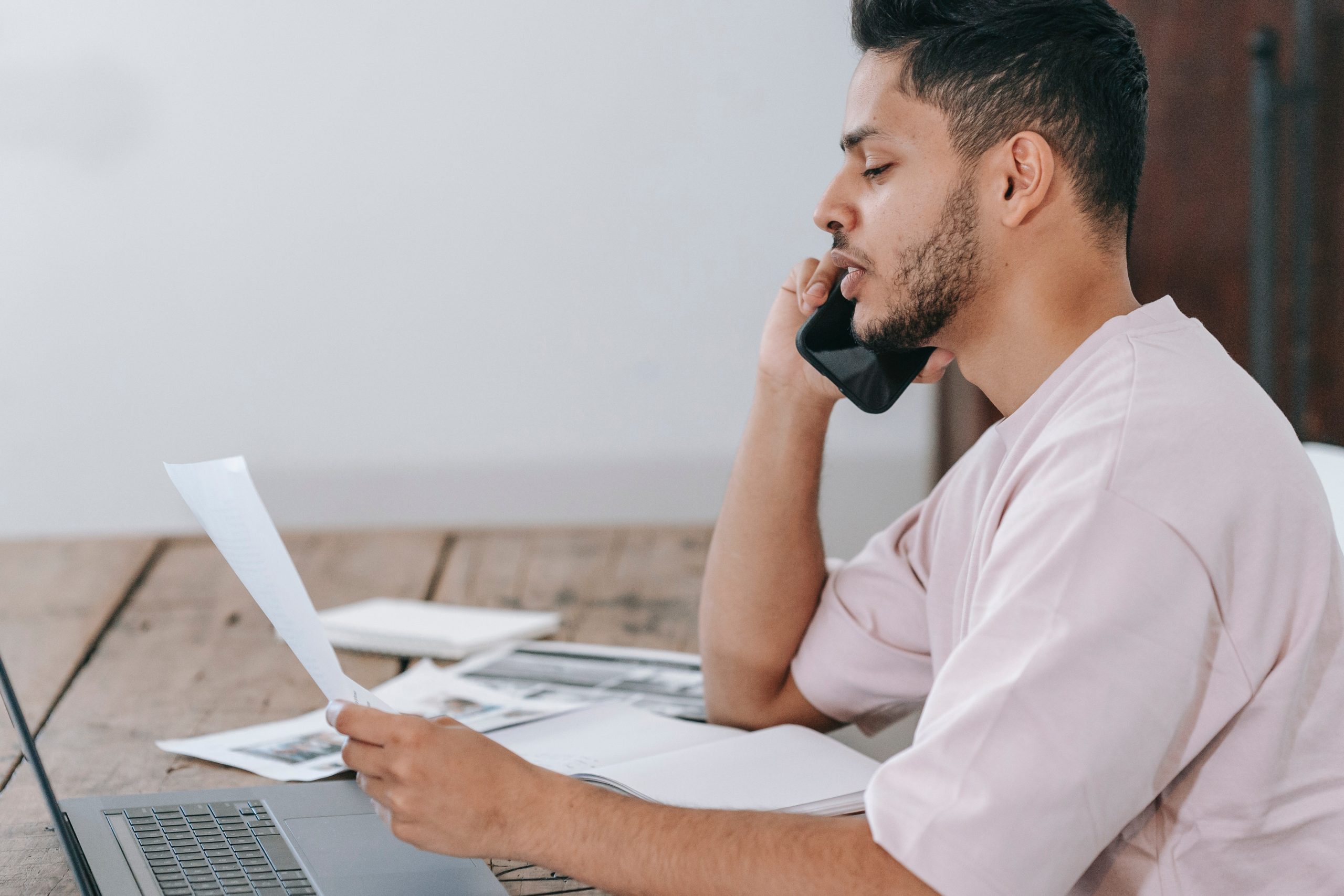 pexels-michael-burrows-7129714 A man standing in an office smiles and gives a thumbs-up sign