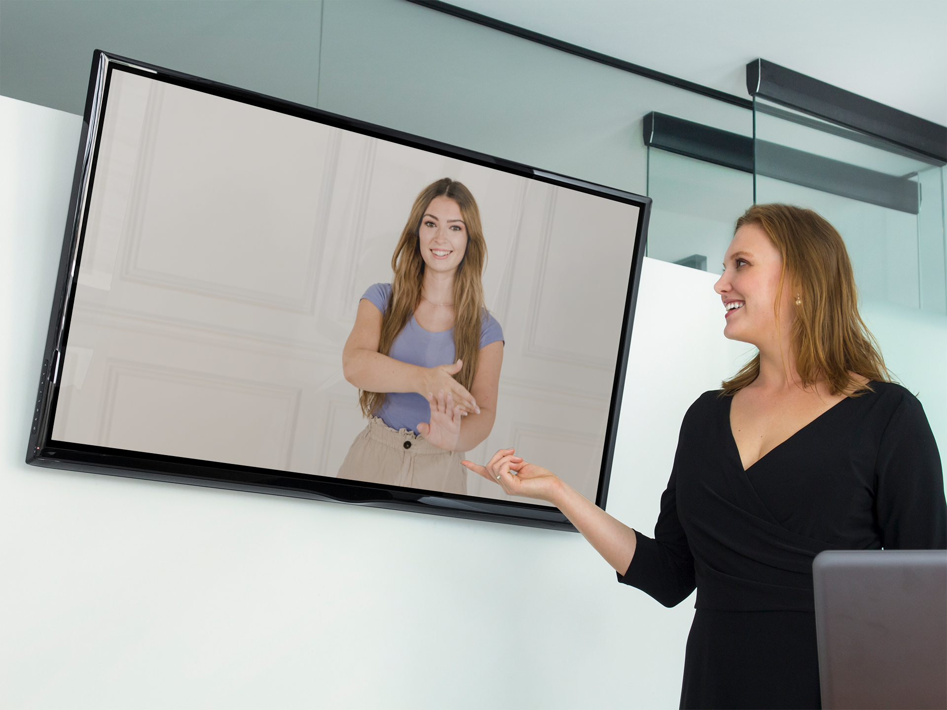 business-woman-with-lg-flat-screen-tv-mockup-template-90980 A woman points to a TV displaying a woman performing sign language